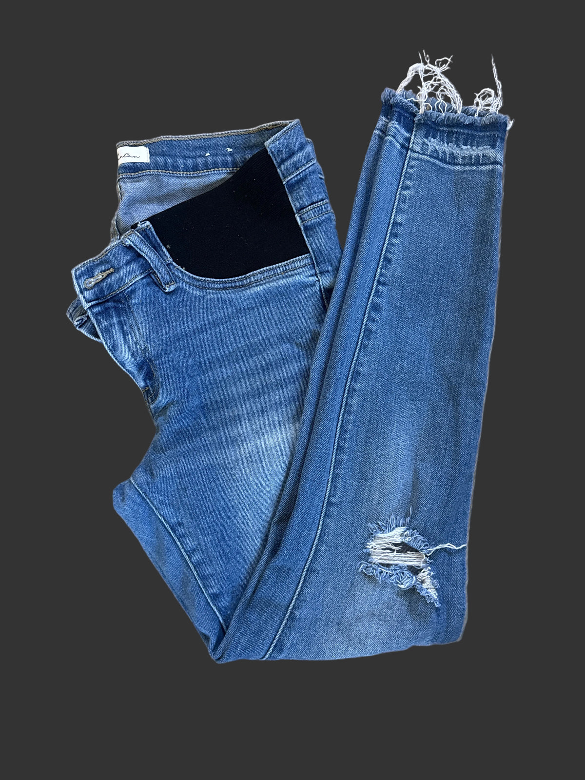 Medium-wash distressed jeans with frayed hems, front view