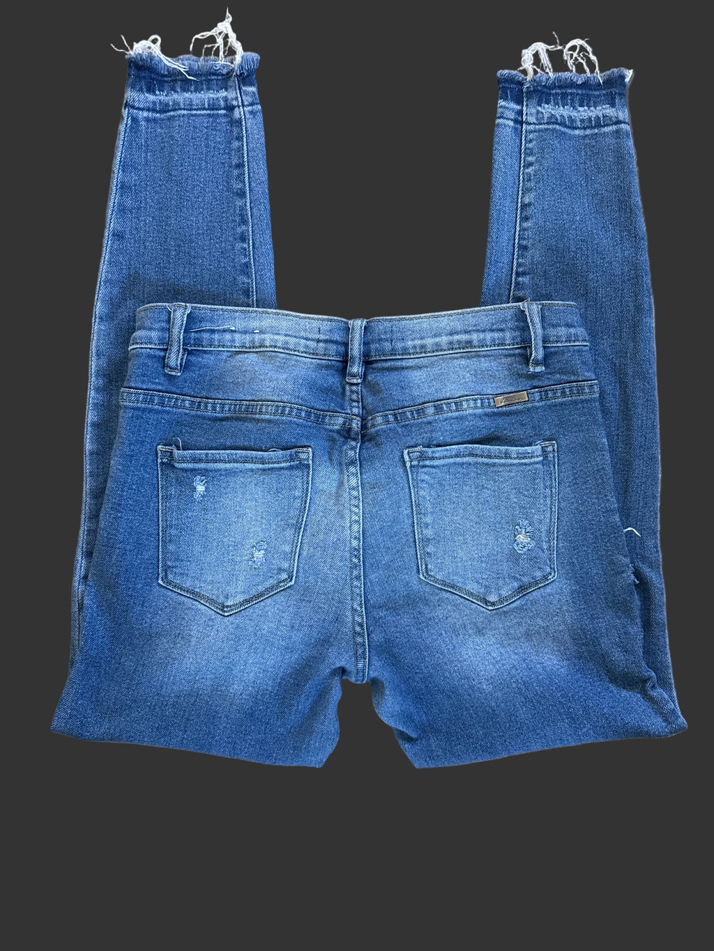 Back view of medium-wash jeans with patch pockets