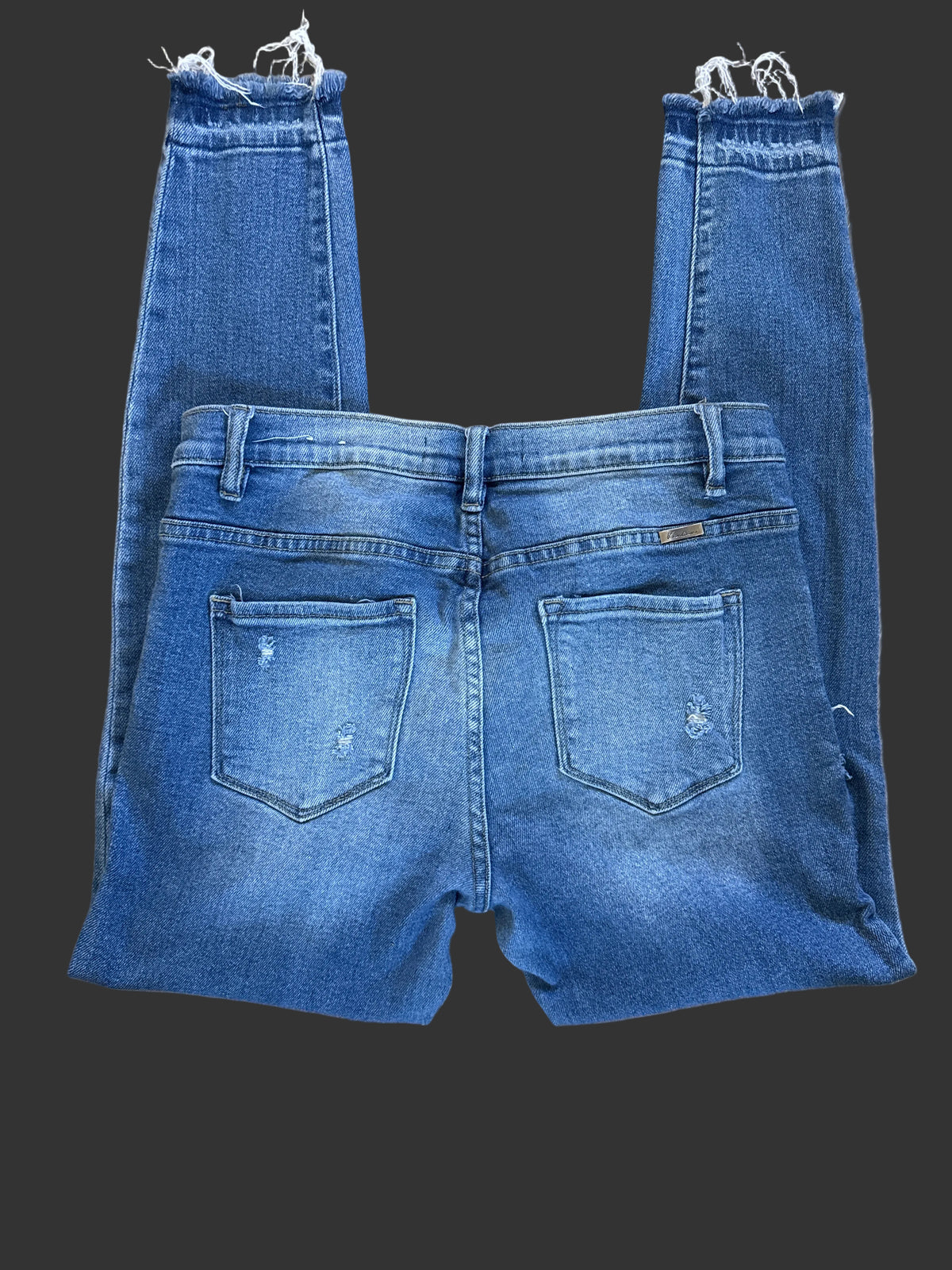 Back view of medium-wash jeans with patch pockets